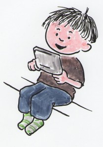 Seated young boy is playing a portable video game..