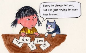 Child looking at flash cards of two and three letter words.